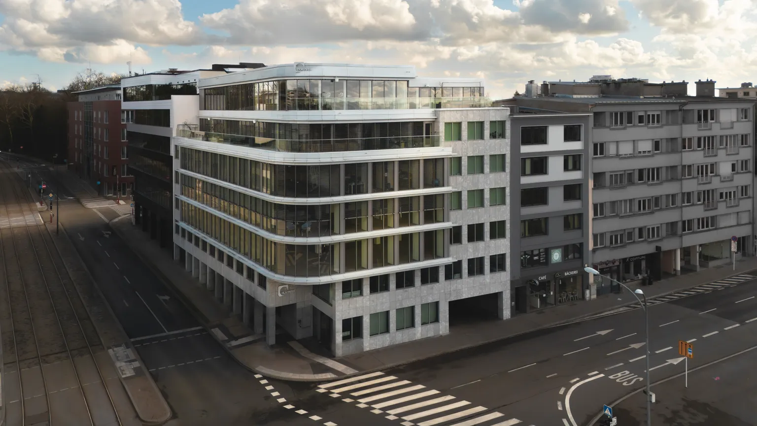 Aerial drone view of DLA Piper's Luxembourg offices beside tram tracks and city streets