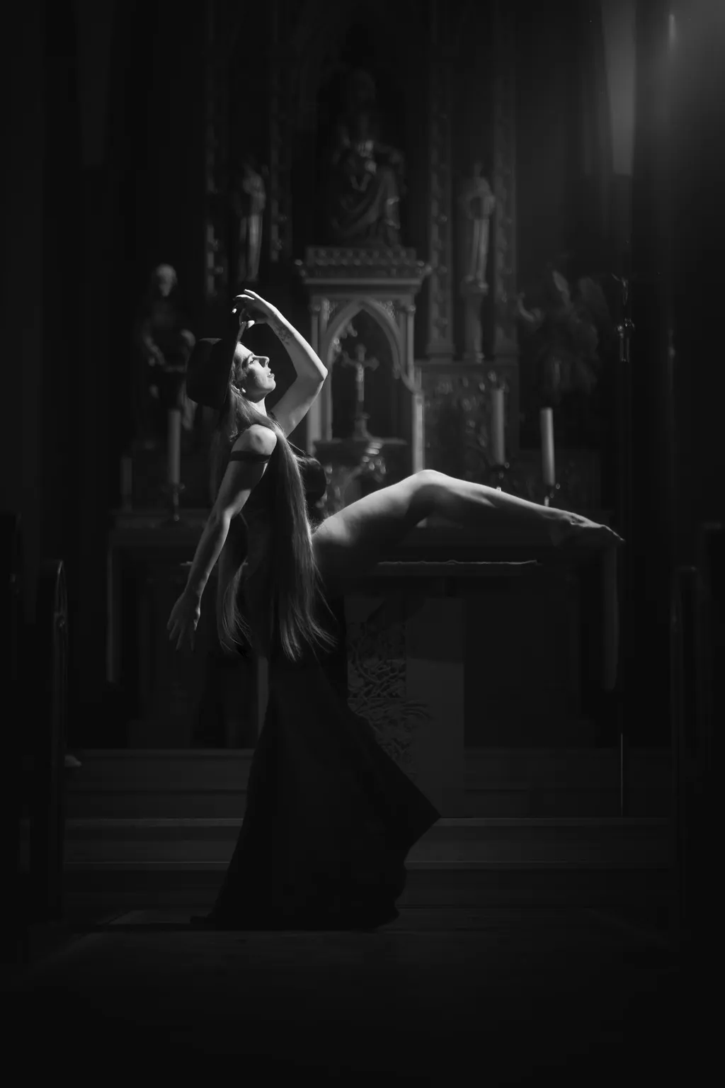 Dramatic black-and-white portrait of a woman arching back in a long gown before a church altar, Luxembourg